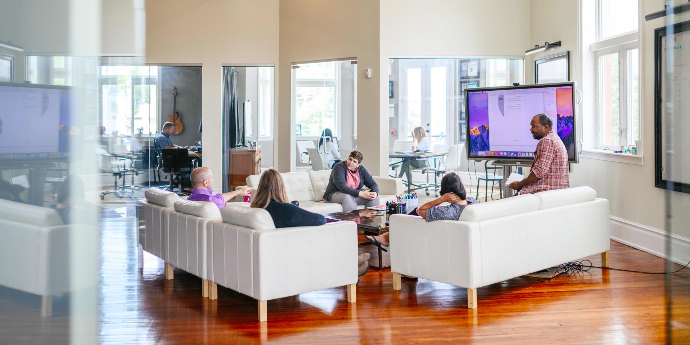 Photo of employees in modern office lounge